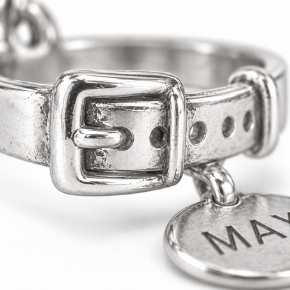 Super macro surface detail of Best Friend Collar Charm from a low oblique angle