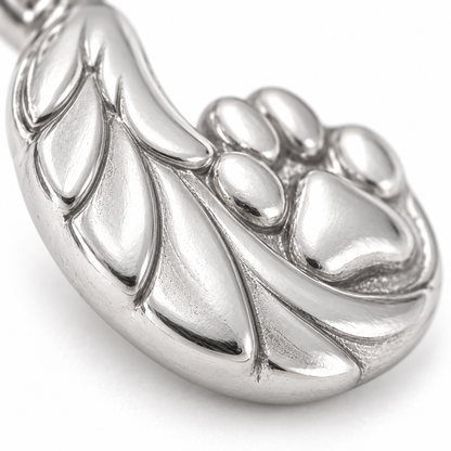 Super macro surface detail of Guardian Angel Paw Charm from a low oblique angle