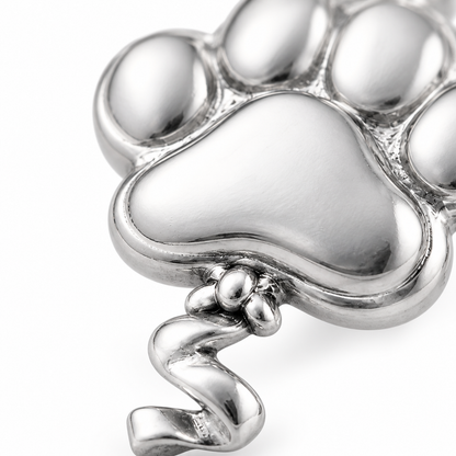 Super macro surface detail of Pawprint Promise Charm from a low oblique angle