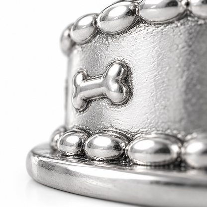 Super macro surface detail of Birthday Pup Charm from a low oblique angle