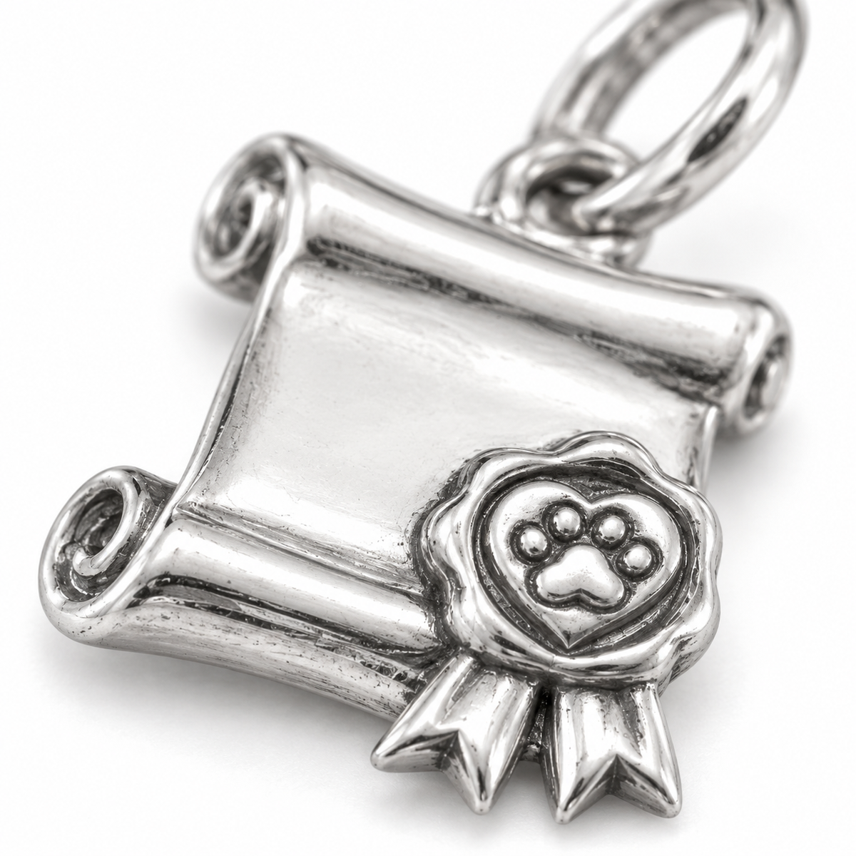 Super macro surface detail of Adoption Promise Charm from a low oblique angle