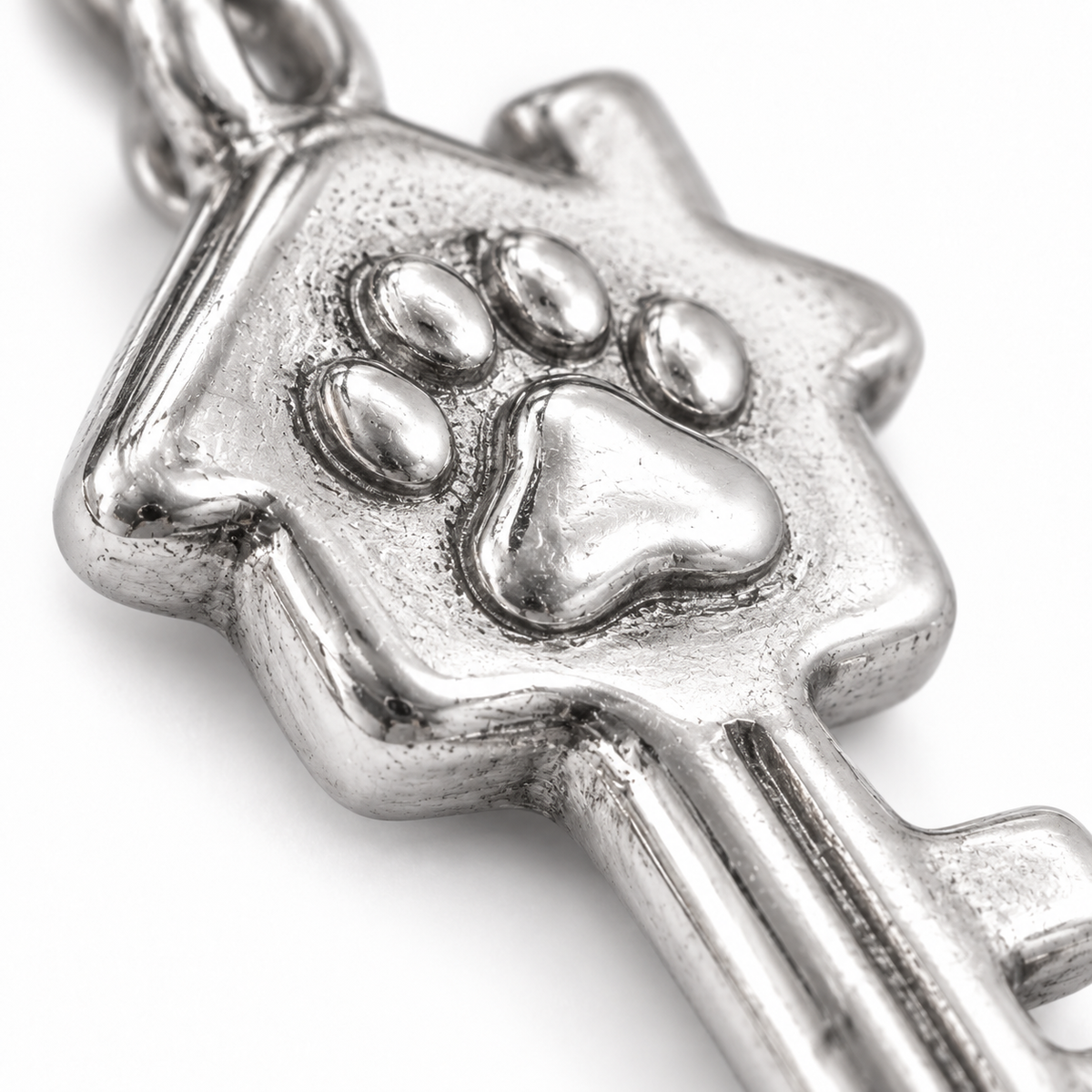 Super macro surface detail of Key to Their Heart Charm from a low oblique angle