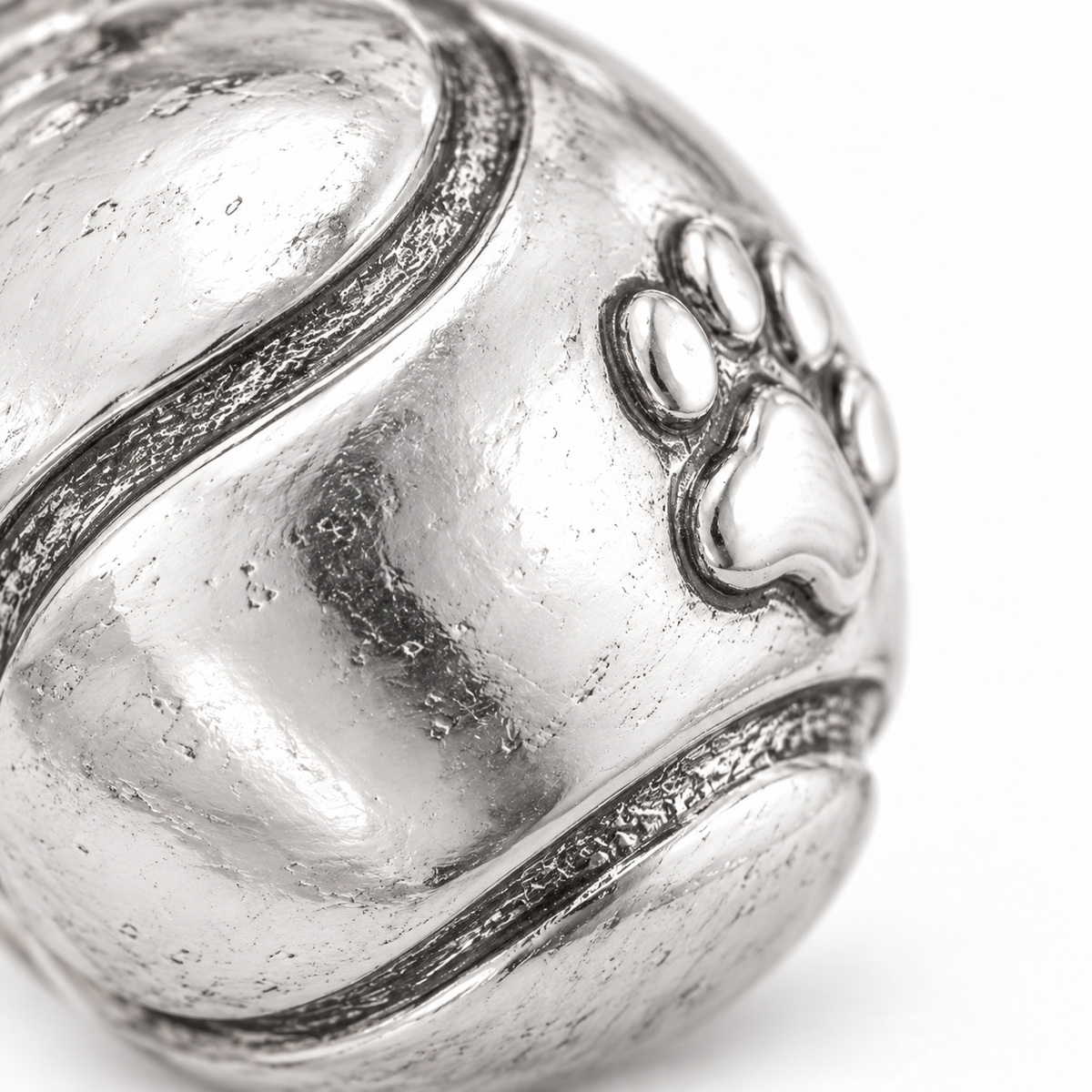 Super macro surface detail of Tennis Ball Bestie Charm from a low oblique angle