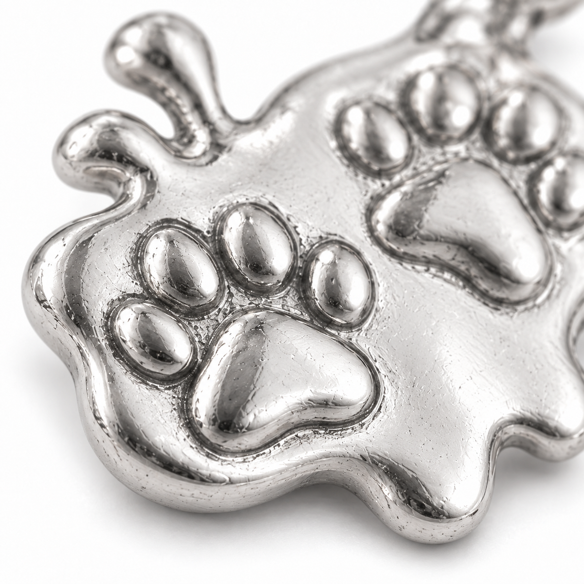 Super macro surface detail of Happy Muddy Paws Charm from a low oblique angle