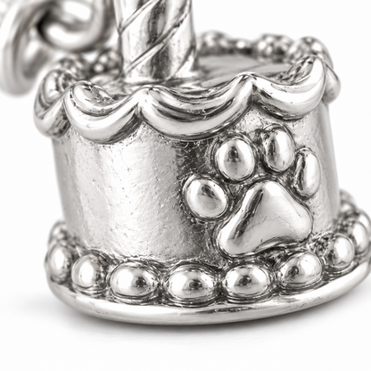 Super macro surface detail of Birthday Wishes Cake Charm from a low oblique angle