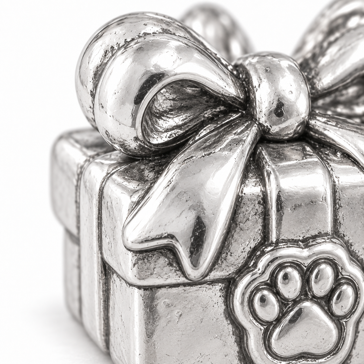 Super macro surface detail of Birthday Surprise Gift Charm from a low oblique angle