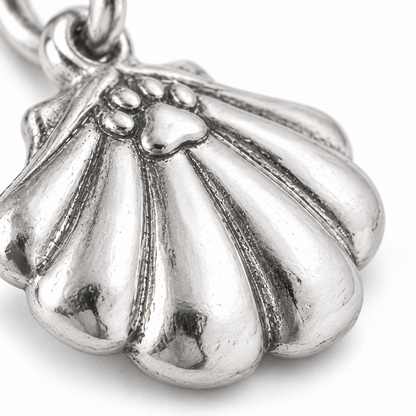 Super macro surface detail of Seaside Paw Shell Charm from a low oblique angle