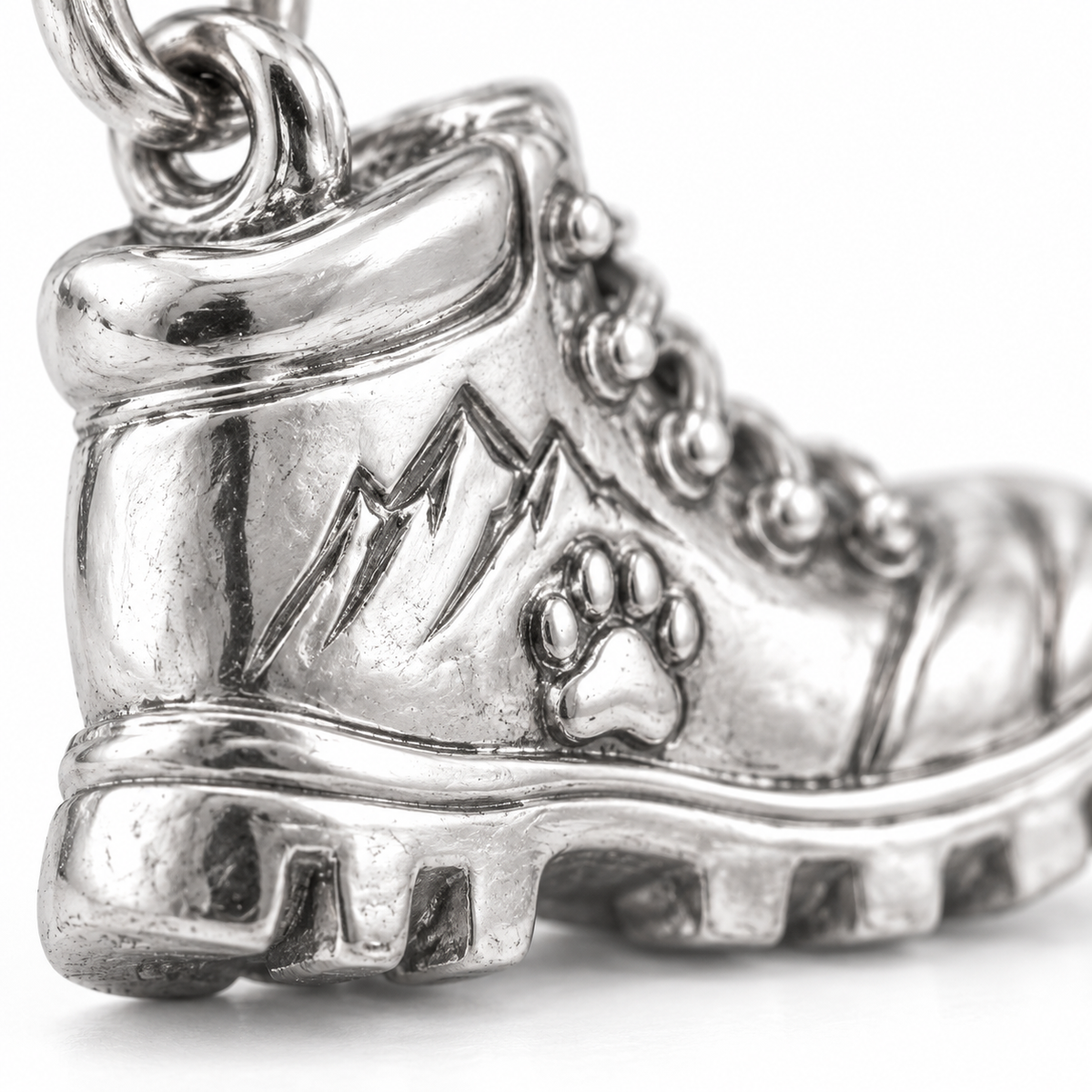 Super macro surface detail of Trail Buddy Boot Charm from a low oblique angle