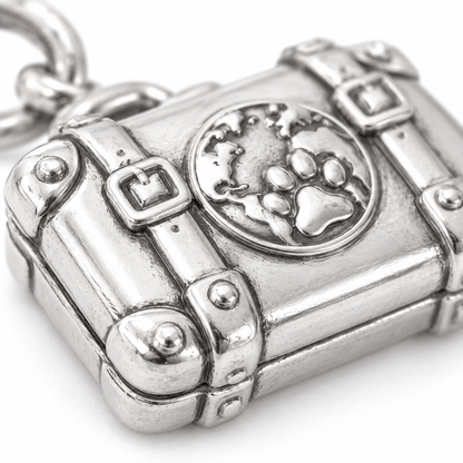 Super macro surface detail of Ready for Adventure Suitcase Charm from a low oblique angle