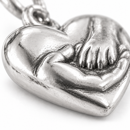 Super macro surface detail of Hand in Paw Heart Charm from a low oblique angle