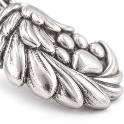 Super macro surface detail of Angel Paw Embrace Charm from a low oblique angle