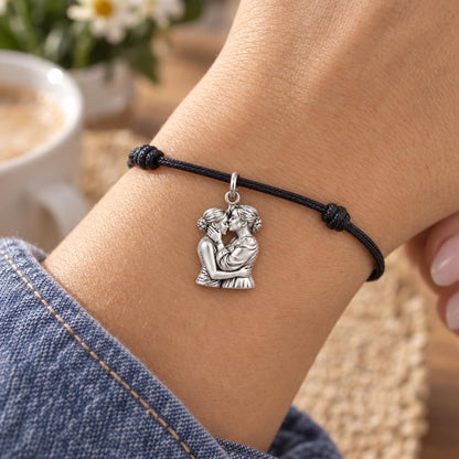 A Mother's Gentle Kiss Charm Bracelet – Personalized Mom Gift – worn on the wrist on a black cord bracelet