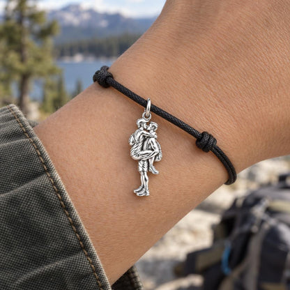 Adventurous Love Embrace Charm Bracelet – Personalized Gay Couple Gift – worn on the wrist on a black cord bracelet