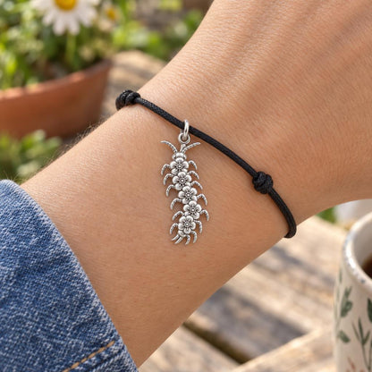 Blooming Centipede Charm Bracelet – Personalized Nature Gift – worn on the wrist on a black cord bracelet