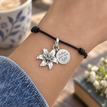 Blooming Lily Charm Bracelet – Personalized Daughter Gift – worn on the wrist on a black cord bracelet