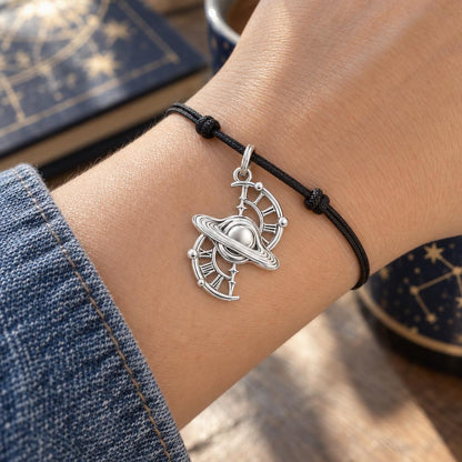 Celestial Time Saturn Charm Bracelet – Personalized Dreamer Gift – worn on the wrist on a black cord bracelet