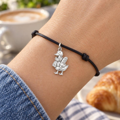 Cozy Baguette Duck Charm Bracelet – Personalized Mom Gift – worn on the wrist on a black cord bracelet