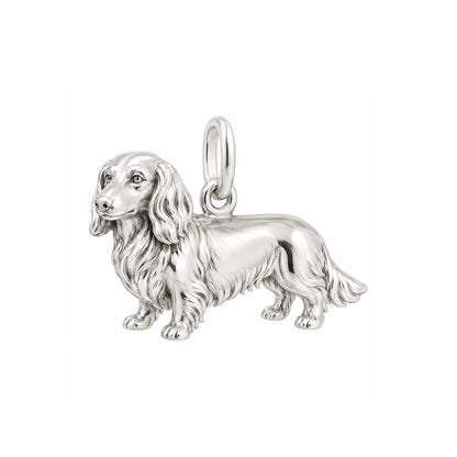 Handmade sterling silver long haired dachshund charm with detailed fur texture and polished finish.