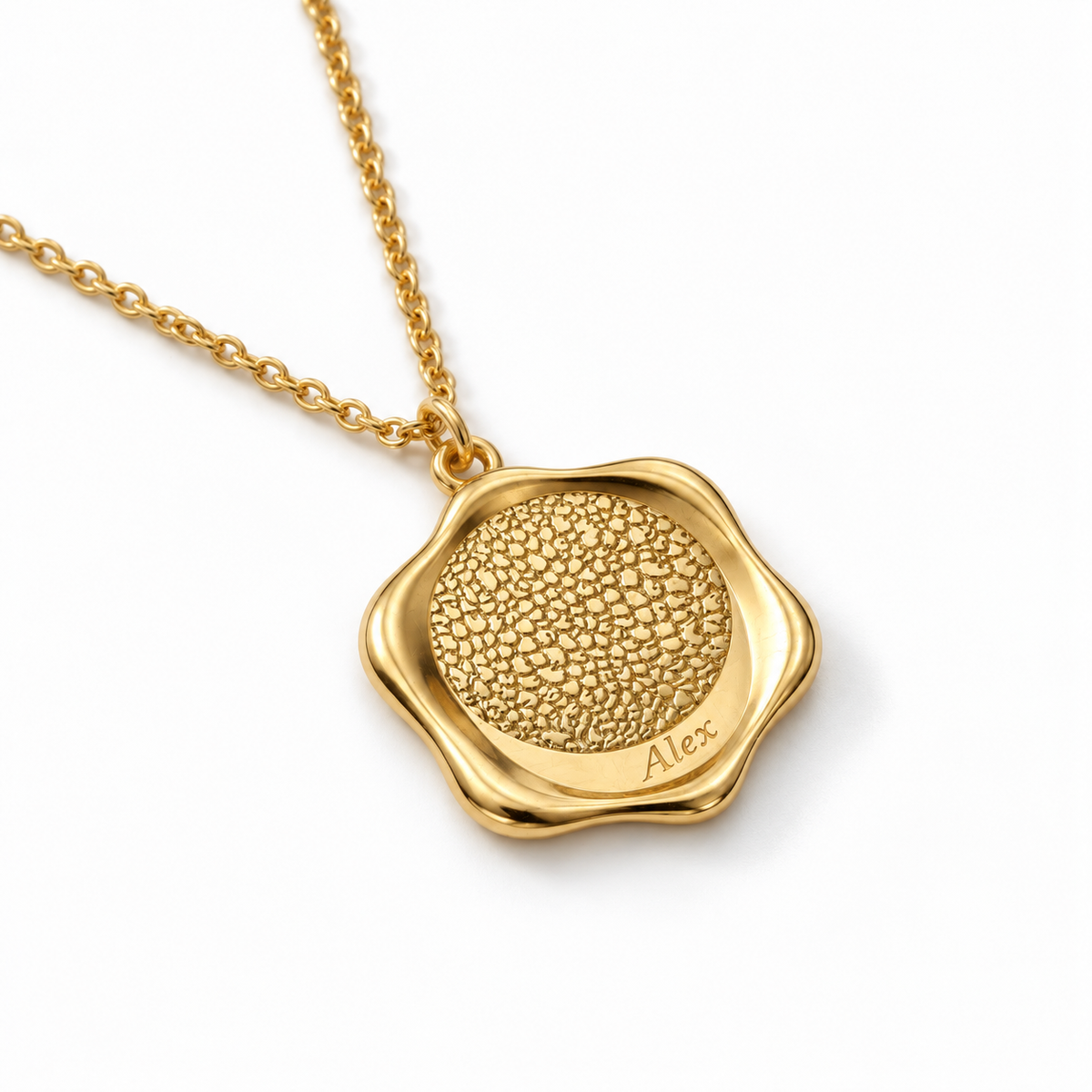 Angled shot of a custom pet nose necklace in gold finish resting on a clean white surface.