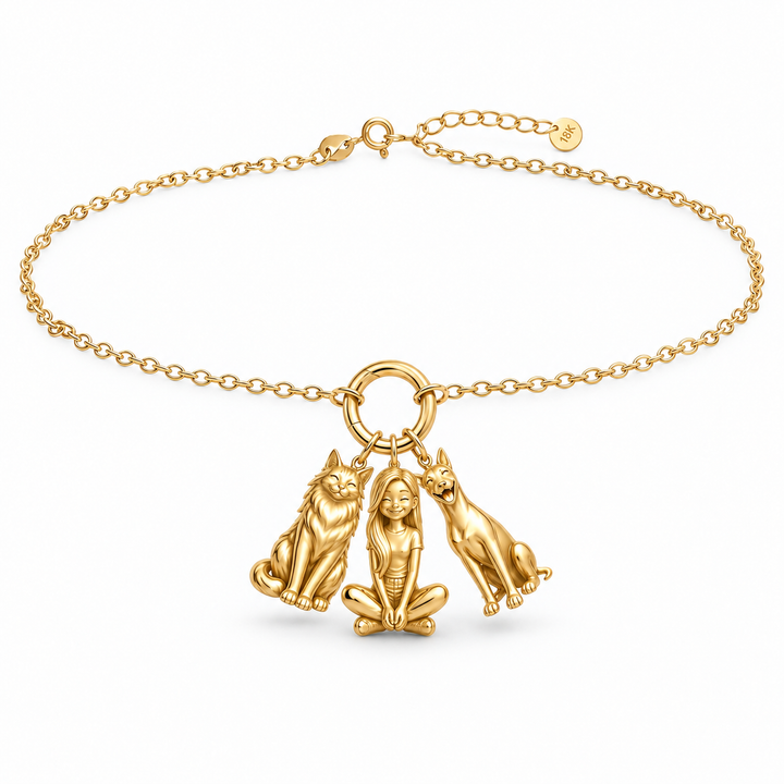 Gold vermeil personalized girl and pets charm bracelet featuring a cat, girl, and dog on a chain.