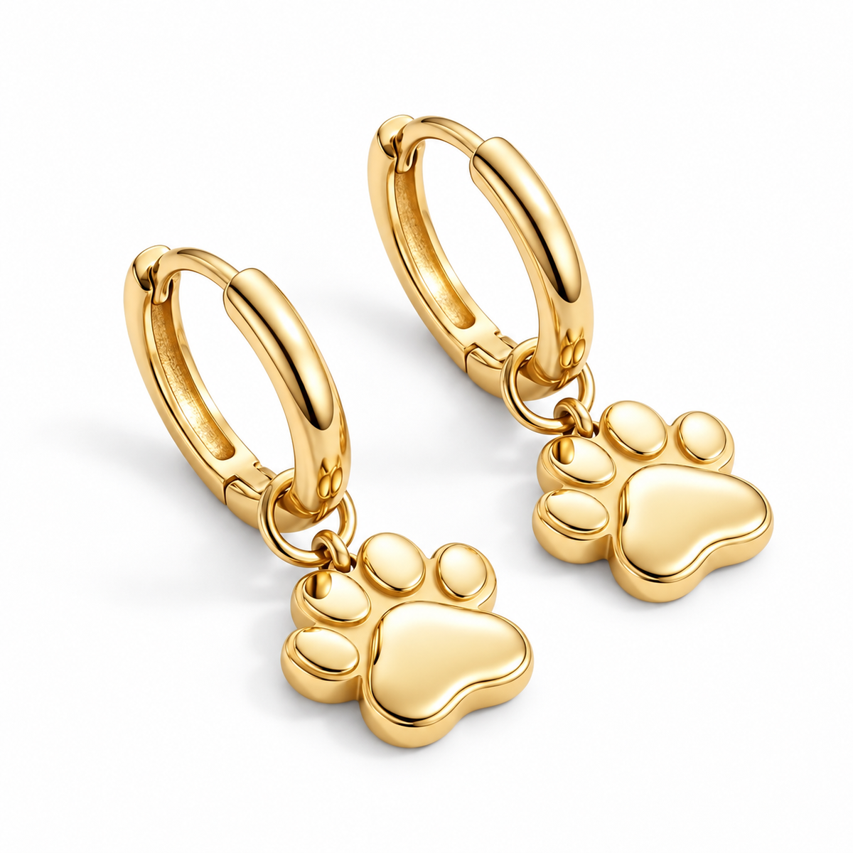 Pair of 18K gold vermeil Little Paw Huggie Earrings with polished charms on a white background.
