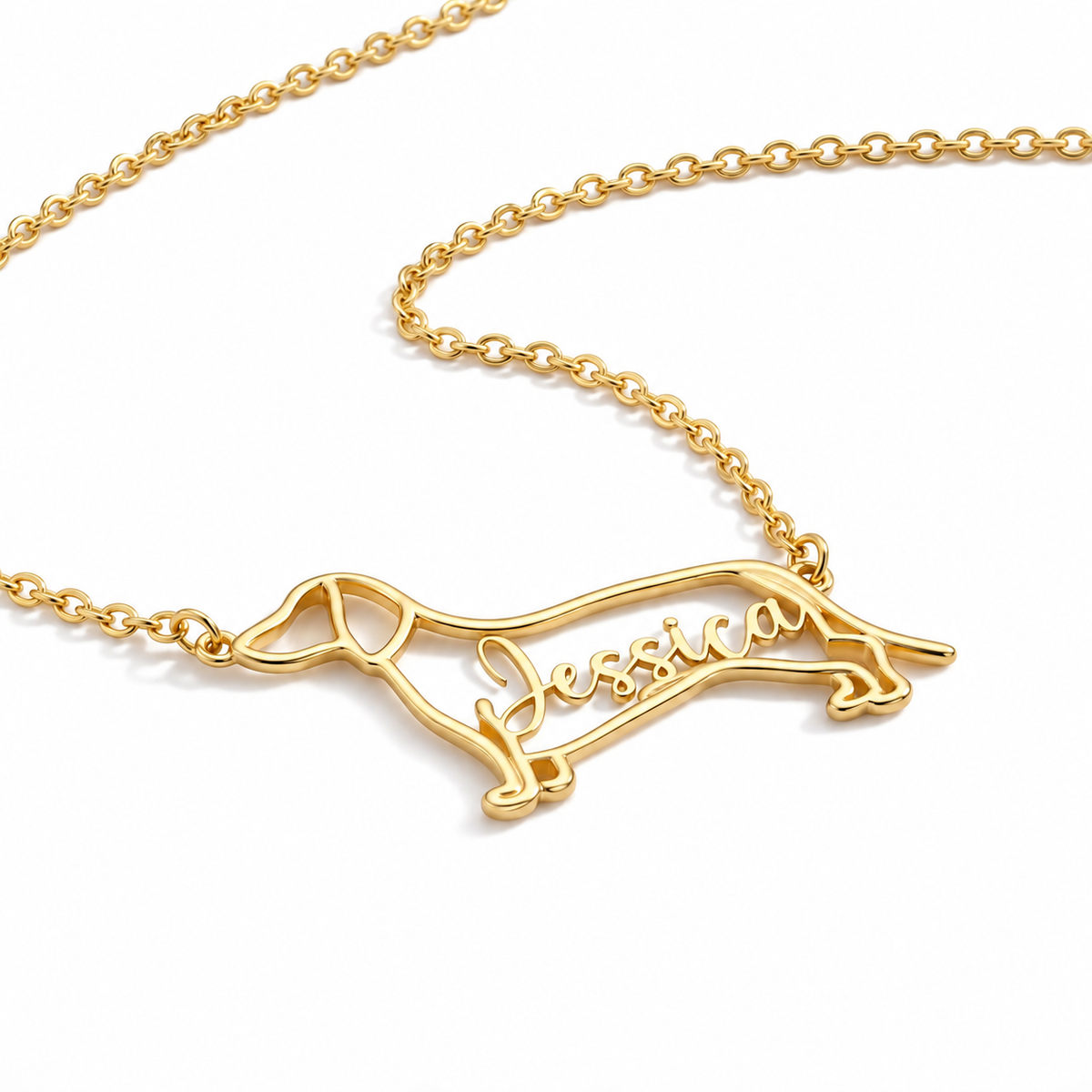 Side view of the handcrafted dog outline pendant in gold showing the delicate chain attachment points.