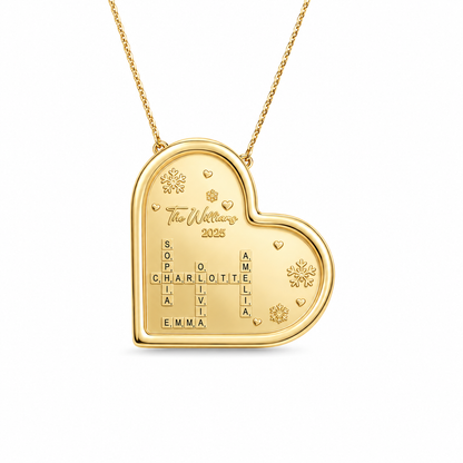 Gold heart shaped pendant with family crossword names and snowflake engravings on a thin cable chain