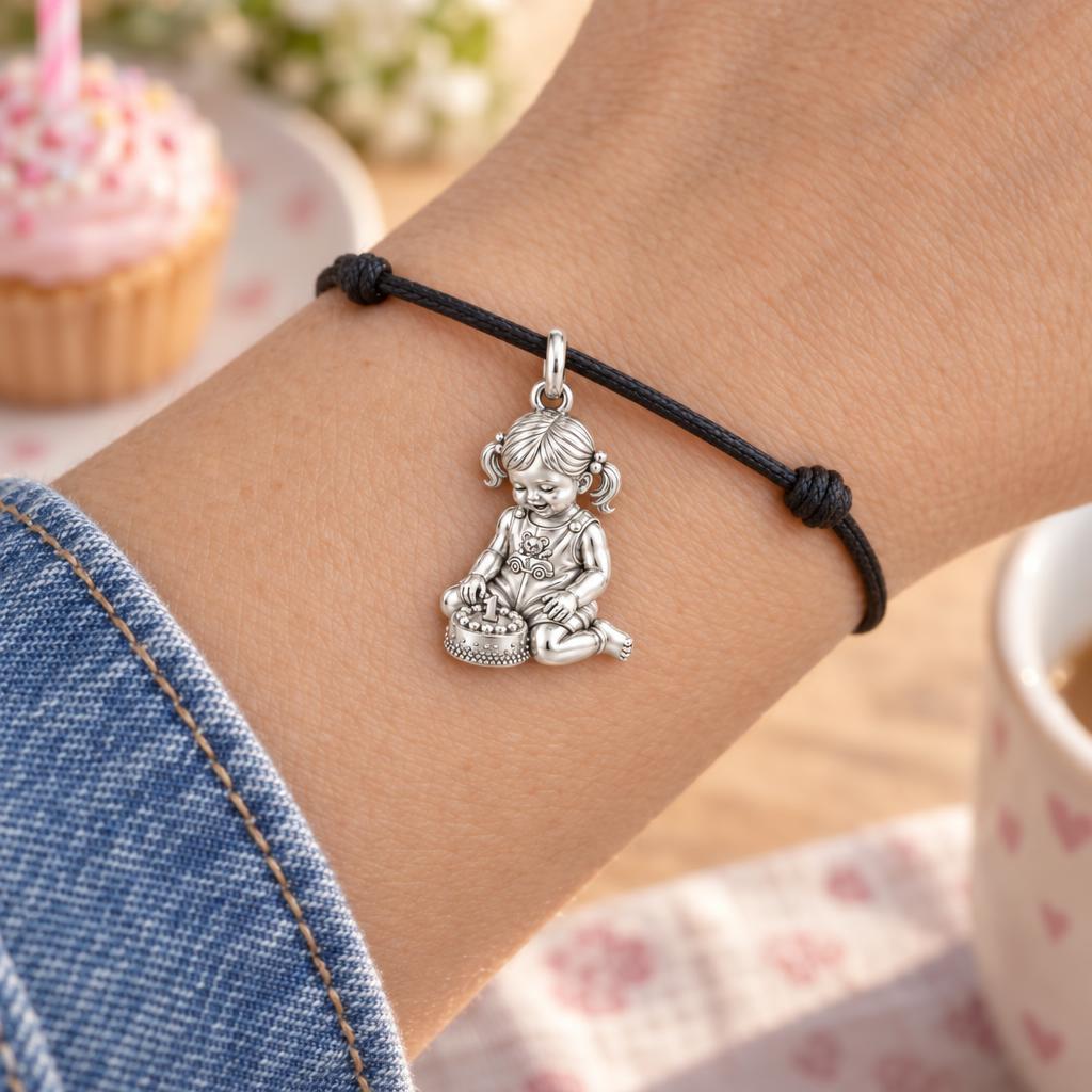 First Birthday Cake Charm Bracelet – Personalized Mom Gift – worn on the wrist on a black cord bracelet