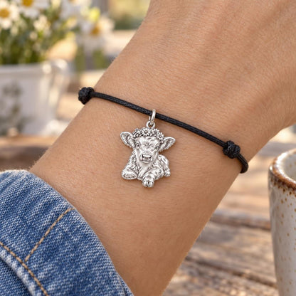 Floral Highland Calf Charm Bracelet – Personalized Mom Gift – worn on the wrist on a black cord bracelet