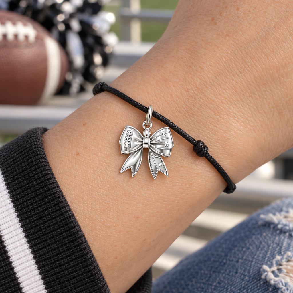 Football Field Bow Charm Bracelet – Personalized Mom Gift – worn on the wrist on a black cord bracelet