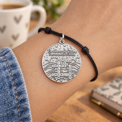 Forever Linked Crossword Charm Bracelet – Personalized Mom Gift – worn on the wrist on a black cord bracelet