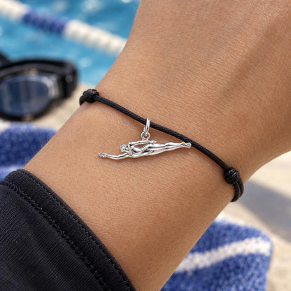 Gliding Swimmer Charm Bracelet – Personalized Athlete Gift – worn on the wrist on a black cord bracelet