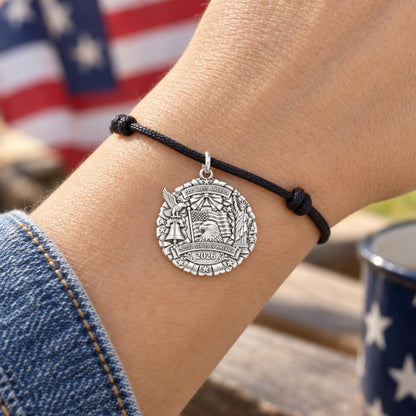 God Bless America Wreath Charm Bracelet – Personalized Veteran Gift – worn on the wrist on a black cord bracelet