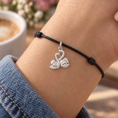 Graceful Swan Pair Charm Bracelet – Personalized Couple Gift – worn on the wrist on a black cord bracelet
