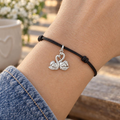 Graceful Swan Pair Charm Bracelet – Personalized Couple Gift – worn on the wrist on a black cord bracelet