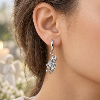 Guiding Star Angel Wing Huggie Charm Earrings – worn / in use