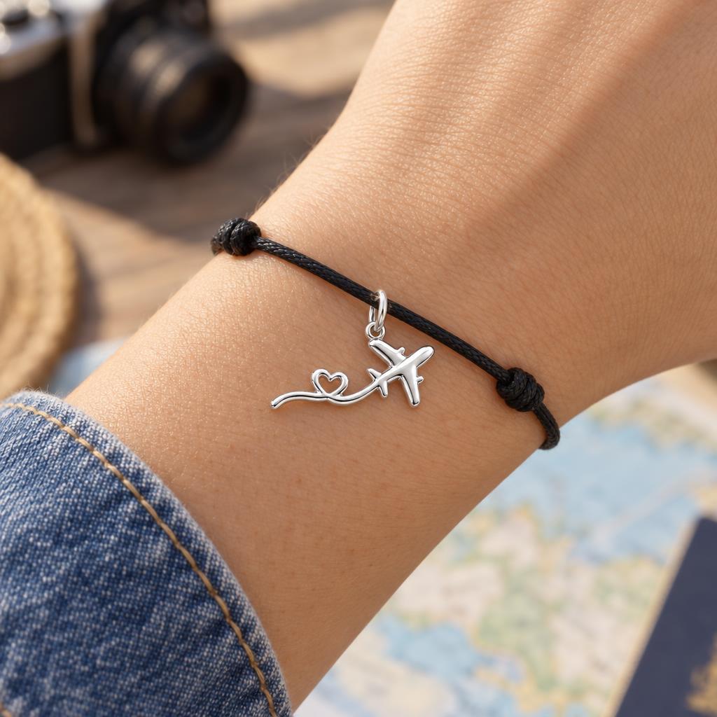 Heartfelt Flight Path Charm Bracelet – Personalized Traveler Gift – worn on the wrist on a black cord bracelet