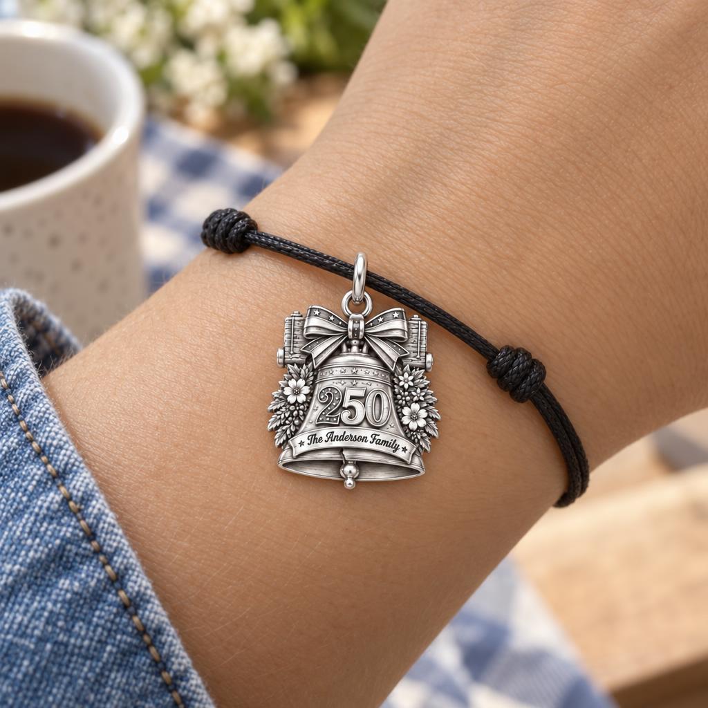 Heritage Anniversary Bell Charm Bracelet – Personalized Family Gift – worn on the wrist on a black cord bracelet