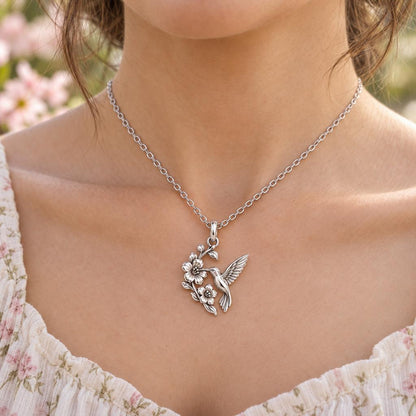 Hummingbird and Cherry Blossom Charm Necklace Set – worn / in use