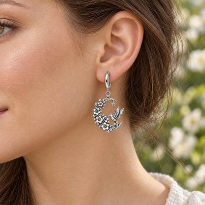 Hummingbird and Moon Blossom Huggie Charm Earrings – worn / in use