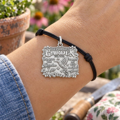 Into the Garden Charm Bracelet – Personalized Mom Gift – worn on the wrist on a black cord bracelet