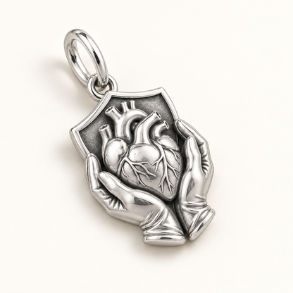 Nurse Protected Heart Dangle Charm | macro face-up oblique view | 51e620ec4fb71142a0ad9e16f2cc5627a2baee62d52bb65b5f505e01cfc17a74