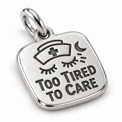 Too Tired to Care Engraved Nurse Charm | macro face-up oblique view | b8c9b50c5d6e431a4432002455543b87fb0dea86d8c1c18943290ff6567d59eb
