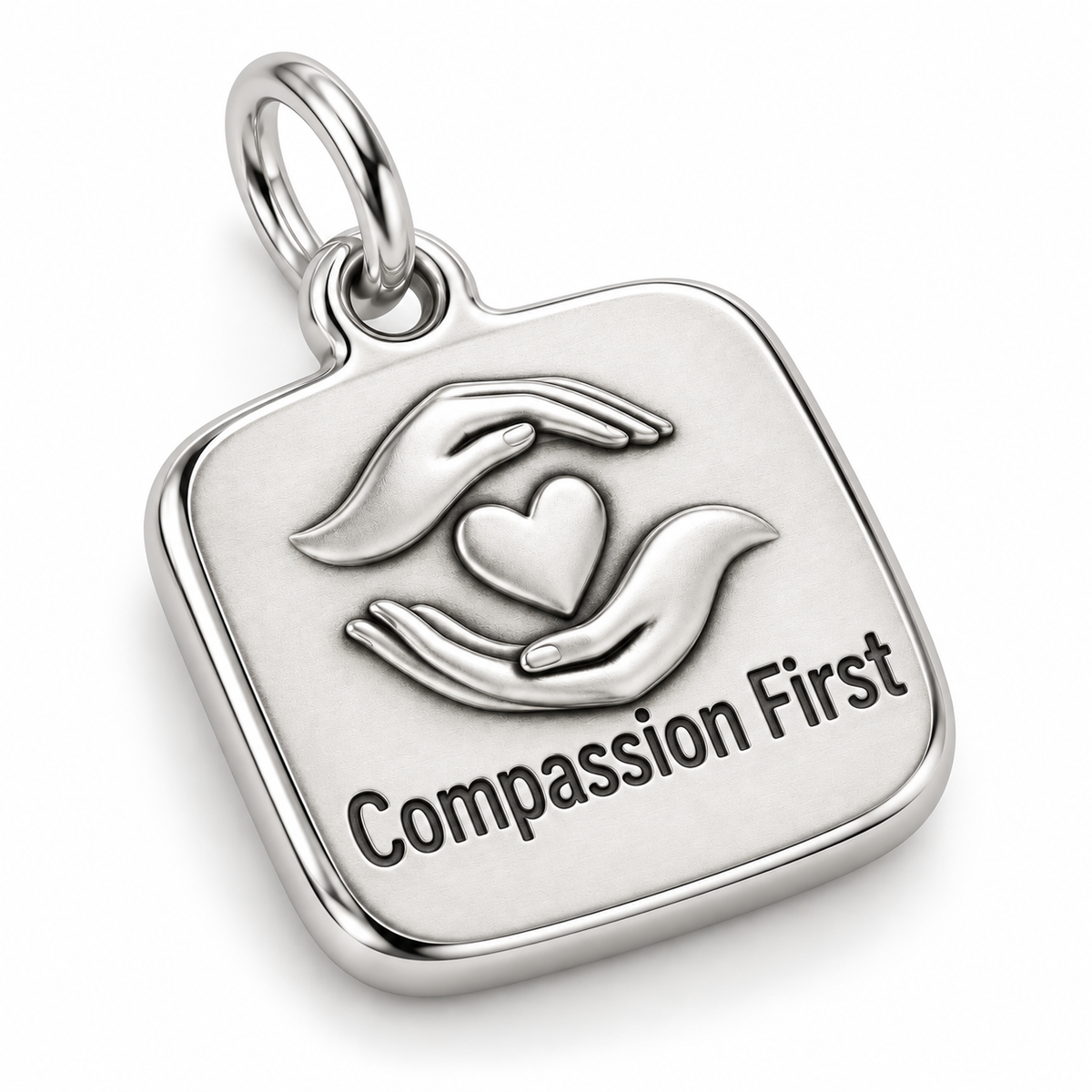 Compassion First Engraved Nurse Charm | macro face-up oblique view | 14ee4d97cf587b6c28372dcaa2ea959b1bb436f2e19eca30e166d2eb26cbc653