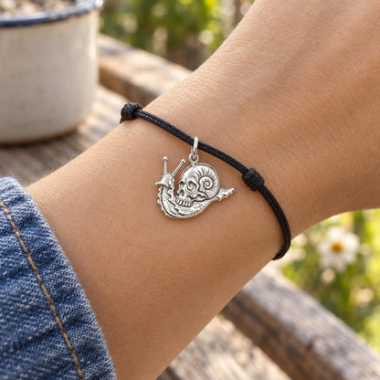 Memento Snail Shell Charm Bracelet – Personalized Nature Gift – worn on the wrist on a black cord bracelet