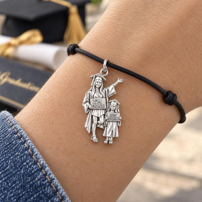 Mother & Daughter Graduation Charm – I'm Done, Just Starting – worn on the wrist on a black cord bracelet