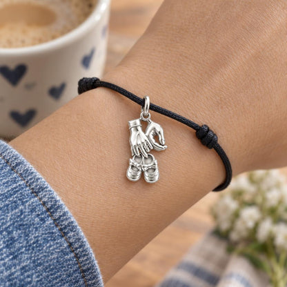 New Chapter Baby Shoes Charm Bracelet – Personalized Mom Gift – worn on the wrist on a black cord bracelet