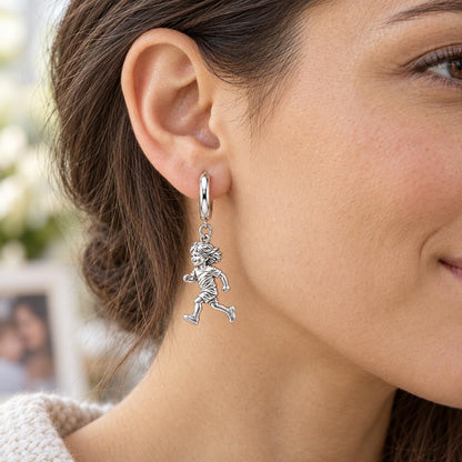 Running Child Joy Huggie Charm Earrings – worn / in use