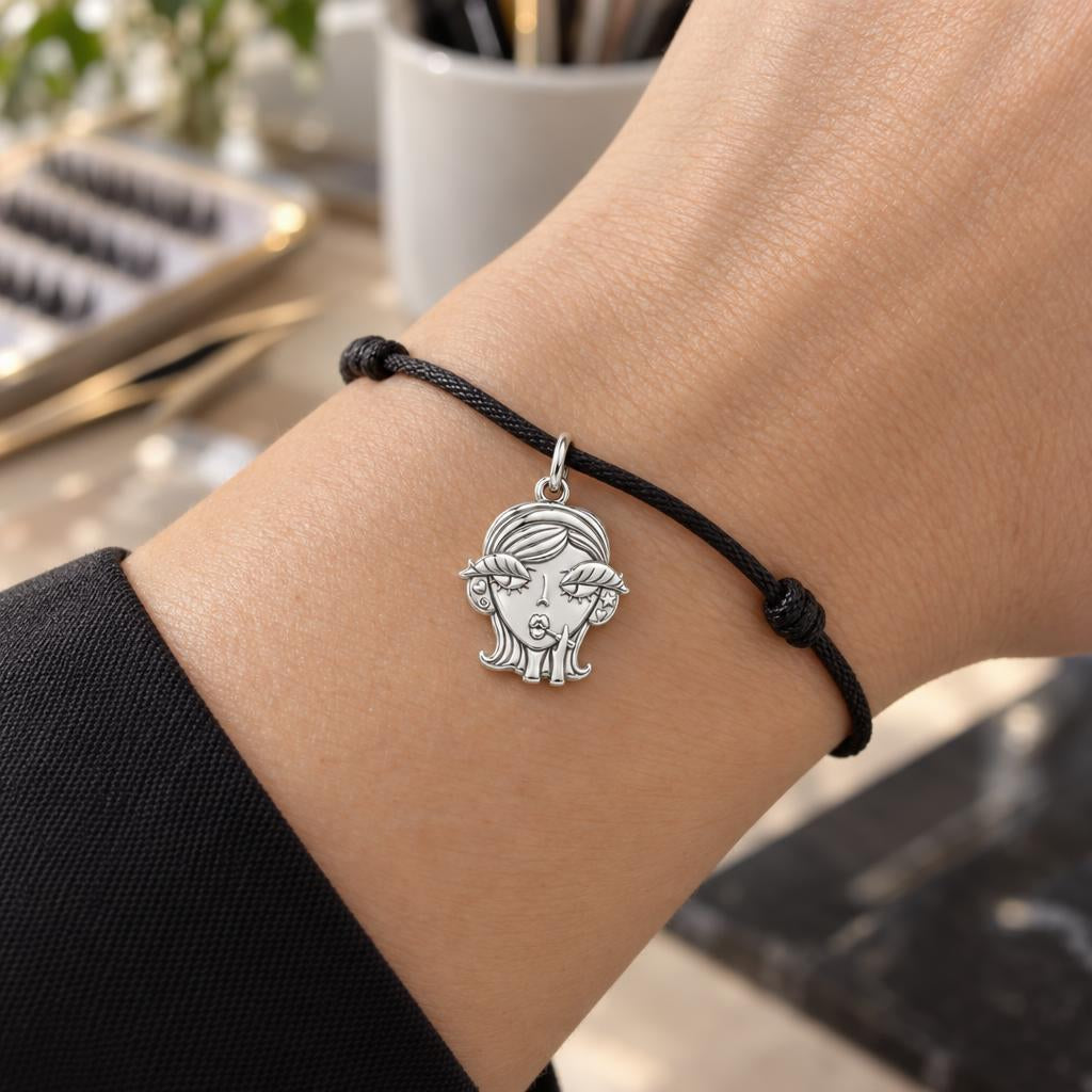 Sassy Girl Silver Charm – Bold Attitude, Iconic Style – worn on the wrist on a black cord bracelet