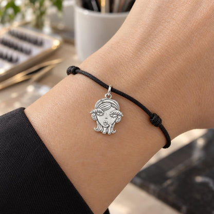 Sassy Girl Silver Charm – Bold Attitude, Iconic Style – worn on the wrist on a black cord bracelet